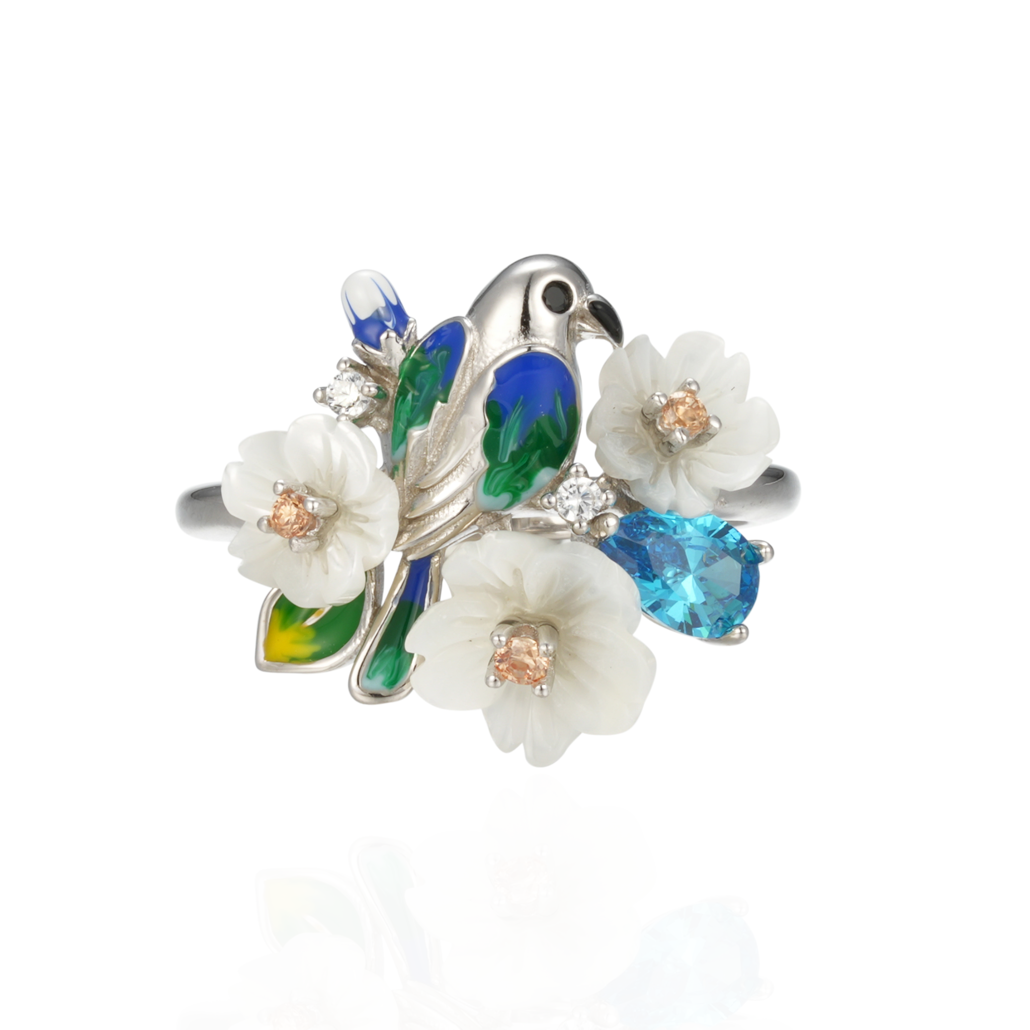 A silver ring with enamel, shell flowers, blue stones and a bird charm.