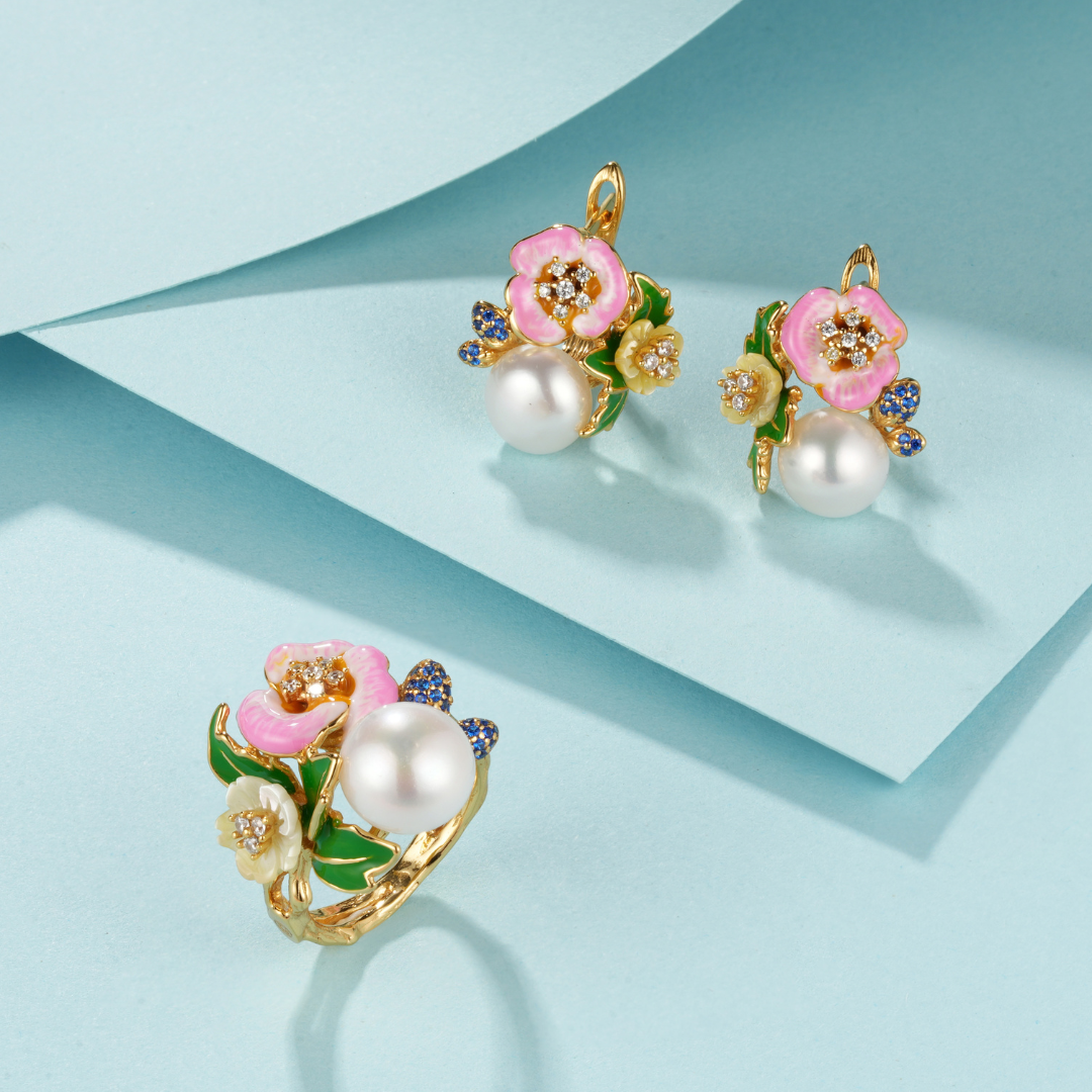 A pair of pink pearl earrings with blue sapphires with enamel and shell flowers