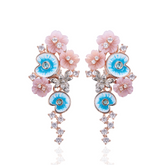 A pair of pink gold plated earrings with pearls, enamel and shell flowers.