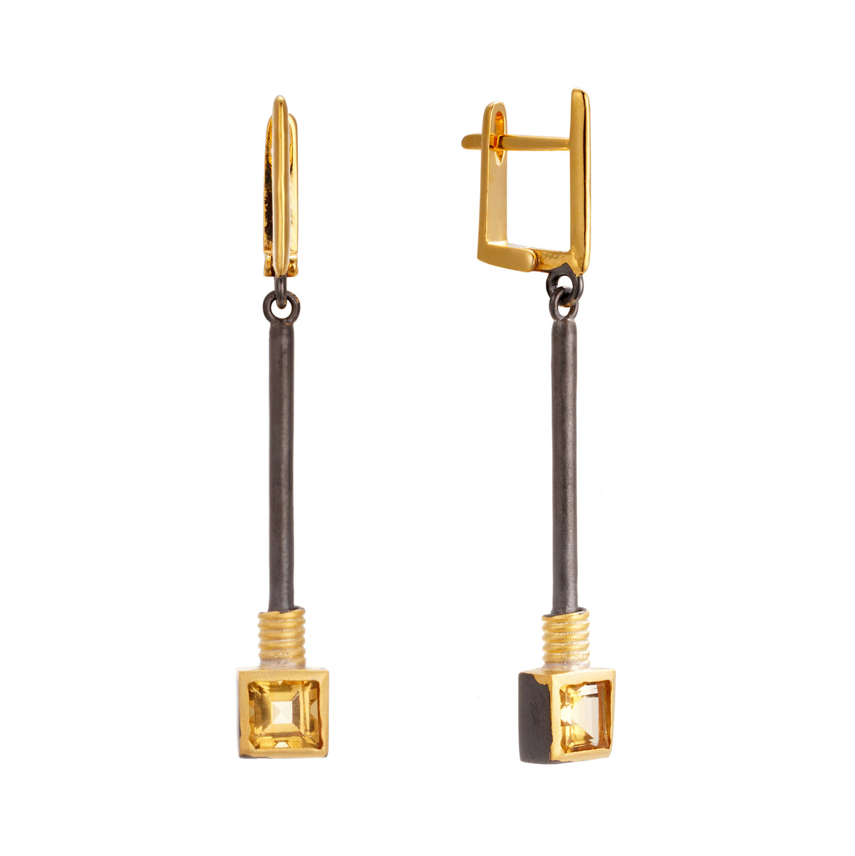 A pair of silver earrings with gold, black rhodium and yellow citrine stones.