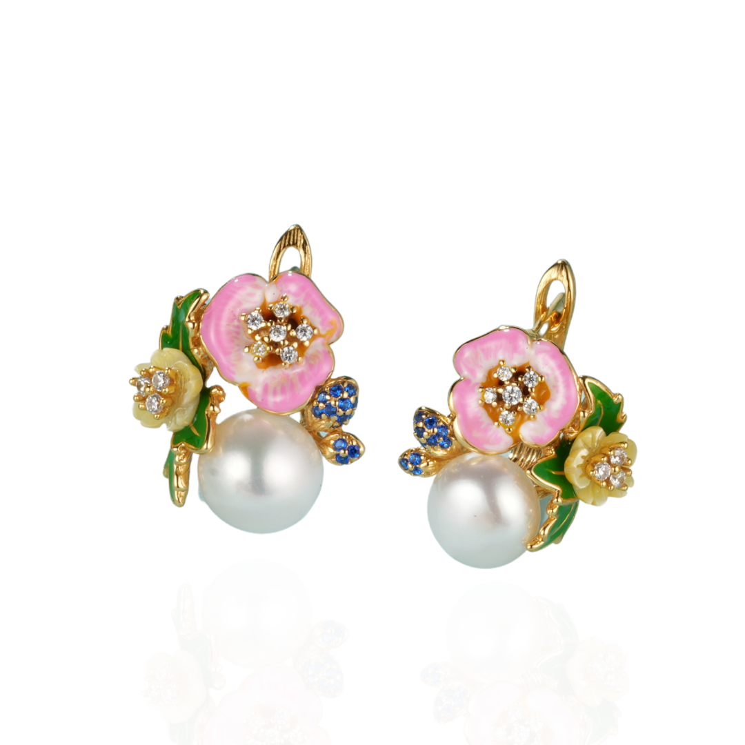 A pair of pink pearl earrings with blue sapphires with enamel and shell flowers
