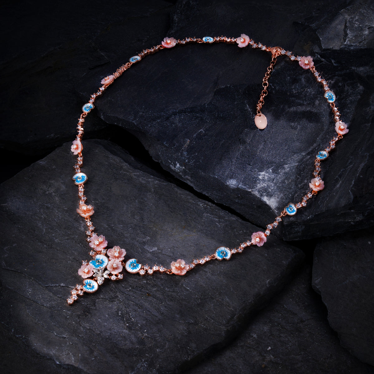 A pink gold plated necklace with enamel, pearls and shell flowers.