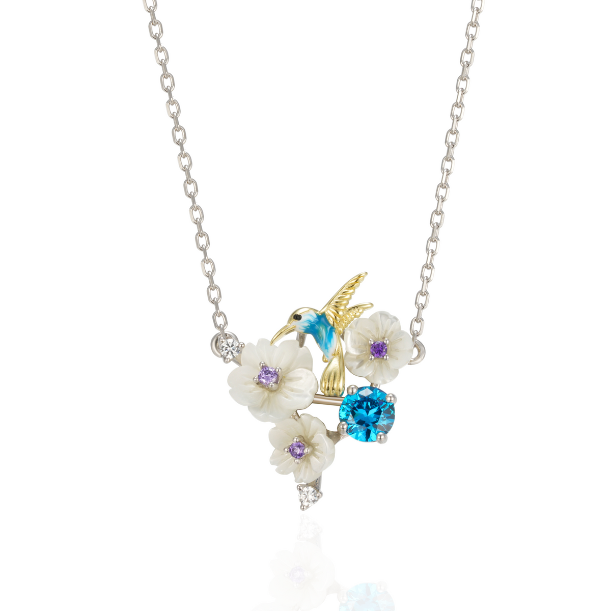 A silver gold plated necklace with a blue stone, enamel, shell flowers and a bird charm.
