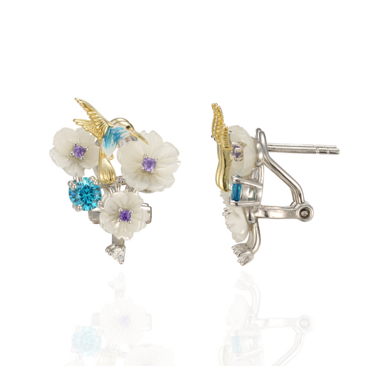 A pair of silver gold plated earrings with blue stones, enamel, shell flowers and a bird charm.